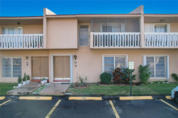Front view of a two-story residential building with balconies.