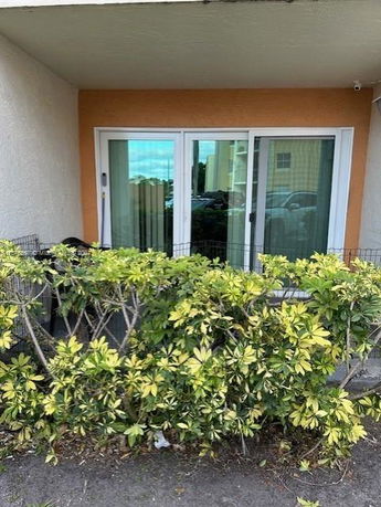 Sliding glass doors with orange trim on a building entrance.
