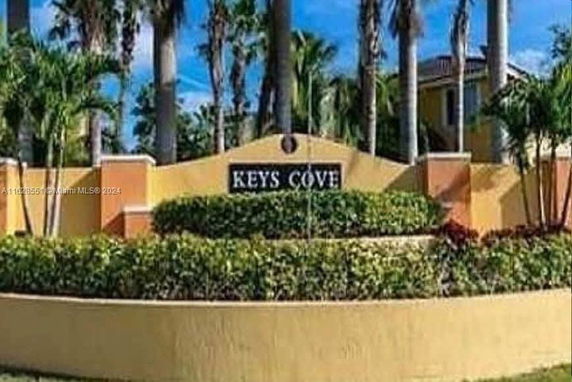 Front view of a sign for Keys Cove community entrance.
