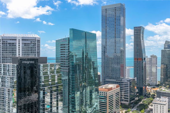 View of modern skyscrapers with glass facades in a cityscape.