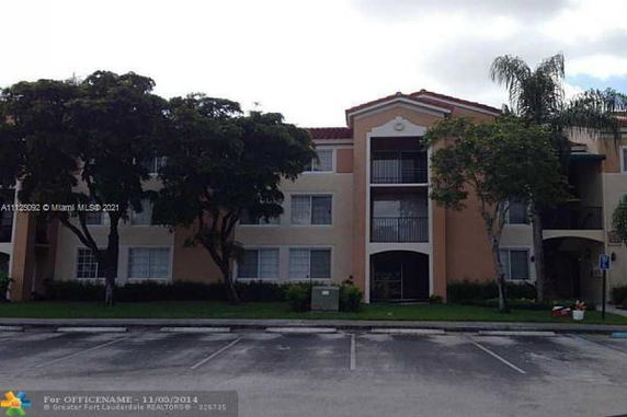 Front view of a multi-story apartment building with balconies.
