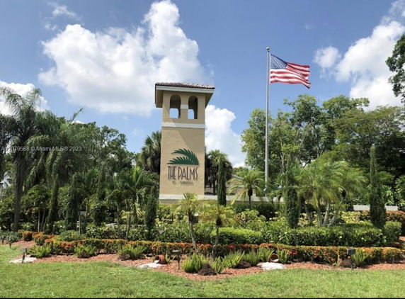 Front view of a building with a tower and an American flag.