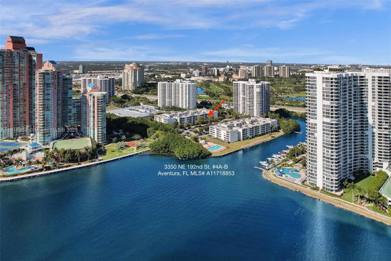 Aerial view of waterfront buildings and high-rise towers in Aventura, FL.