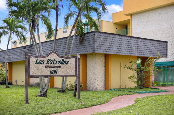 Front view of a condominium building with a decorative sign that reads 'Las Estrellas Condominium 606'.