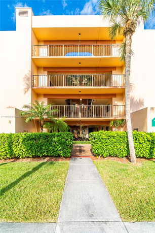Front view of a multi-story building with balconies.