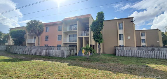 Front view of a multi-story residential building with balconies.