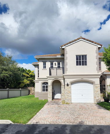 Front view of a two-story house with a single garage and a small balcony.