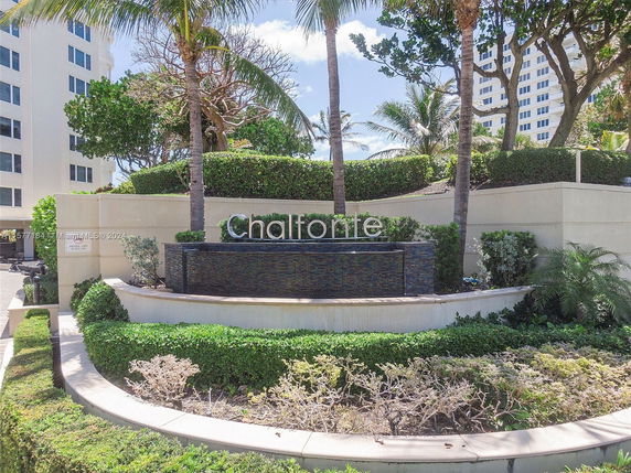 Front view of a multi-story residential building with a landscaped area and a sign reading 'Chalfonte.'