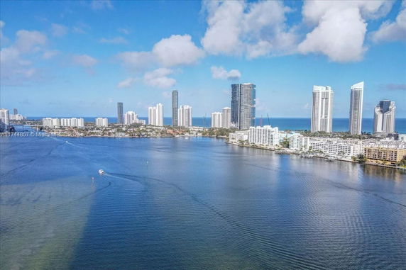 Panoramic view of high-rise buildings near a body of water.