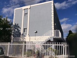 Front view of a multi-story building with a staircase.