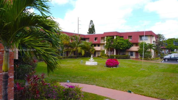 Front view of a two-story residential building with a red roof.