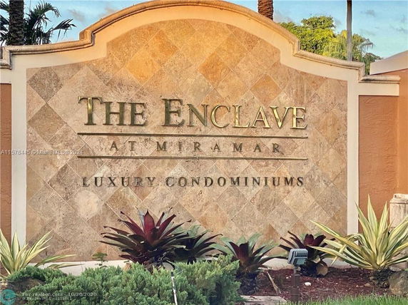 Front view of a stone signage for luxury condominiums.