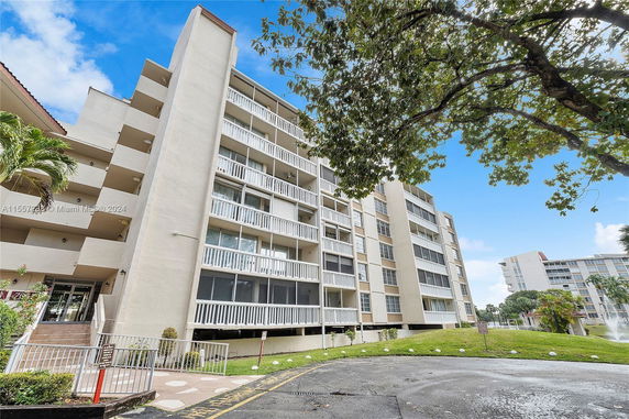Front view of a multi-story apartment building with balconies.