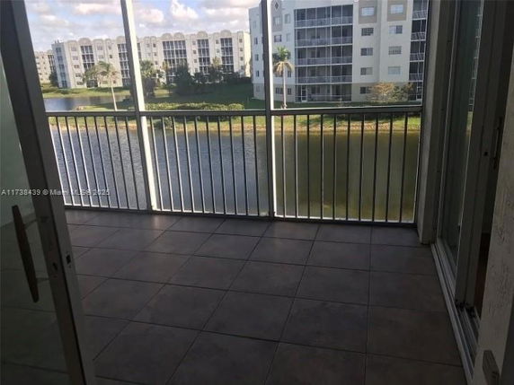 Balcony view overlooking water and nearby apartment buildings.
