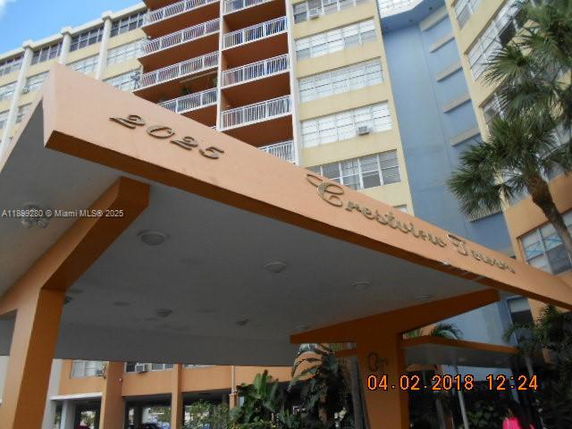 Front view of a multi-story building with an entrance canopy.