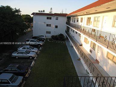 Outdoor parking area adjacent to a multi-story building.