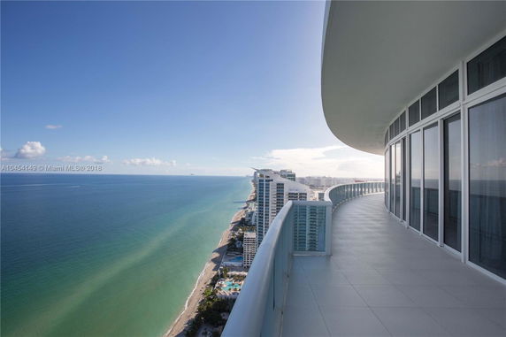 Panoramic view from a building overlooking the ocean and coastline.