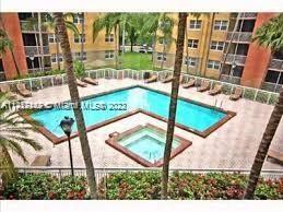 View of a swimming pool area surrounded by apartment buildings.