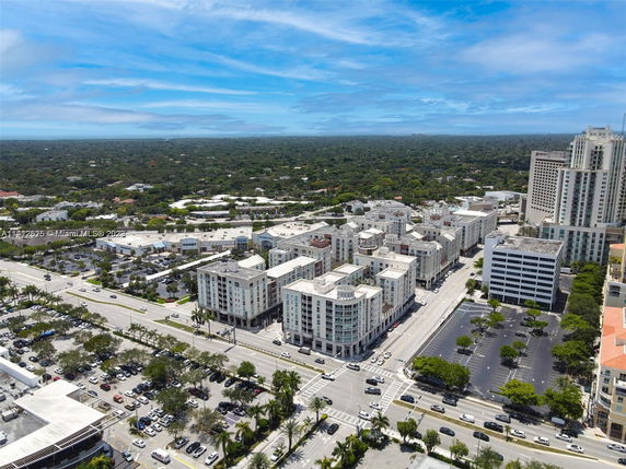 Aerial view of a cityscape with multiple buildings and roads visible.