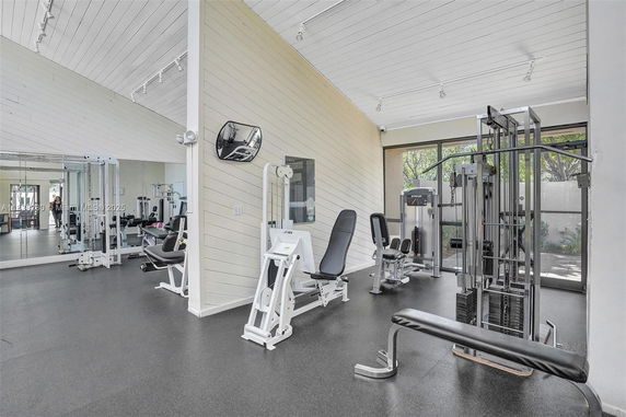 Interior of a gym with exercise equipment and mirrored walls