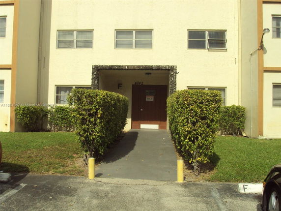 Front view of a multi-story building with a central entrance.