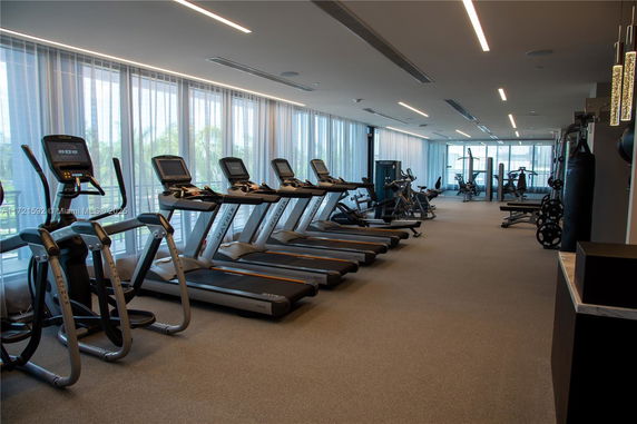 Interior view of a modern gym with treadmills and exercise equipment.