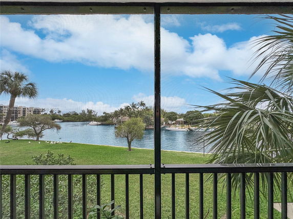 Wide angle view of water and surrounding greenery seen from a building.