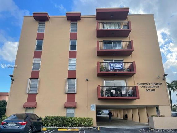 Front view of a multi-story condominium building with balconies.
