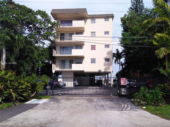 Front view of a multi-story apartment building with balconies.