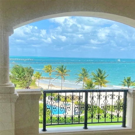 Ocean view seen from a balcony with ornate railing.