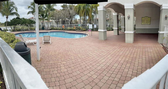 Outdoor swimming pool area with surrounding deck and seating.