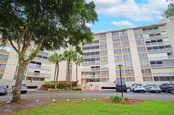 Front view of a multi-story residential building with balconies.