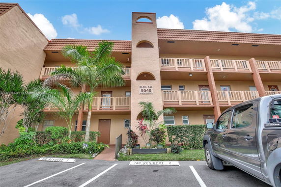 Front view of a multi-story building with balconies.