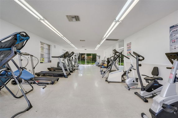 Interior view of a gym with various exercise equipment.