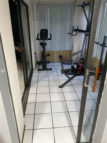 Indoor gym area with fitness equipment.