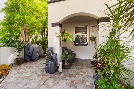 Front view of a building with a small outdoor patio and plants.