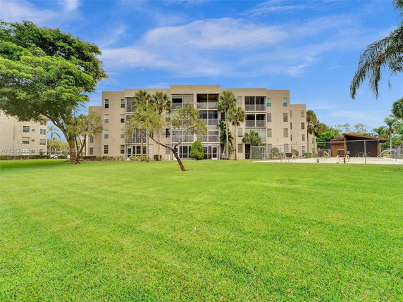 Front view of a multi-story residential building with balconies.