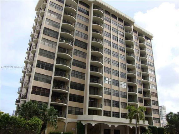 Front view of a multi-story residential building with balconies.