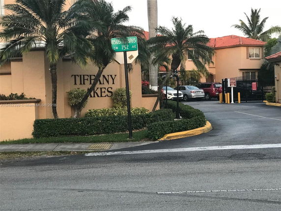 Front view of a residential building with a gated entrance.