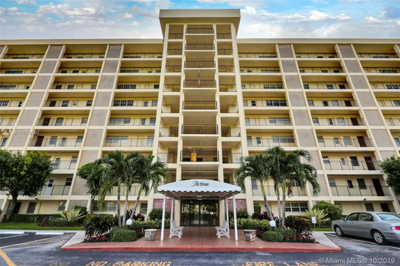 Front view of a multi-story residential building with balconies.