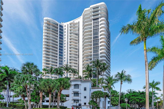 Front view of a high-rise condominium building with balconies.