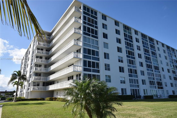 Front view of a multi-story apartment building with balconies.