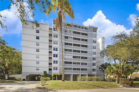 Front view of a multi-story residential building with balconies.