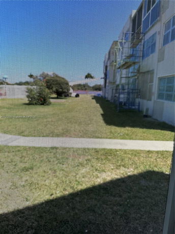 View from a building showing grass and surrounding area.