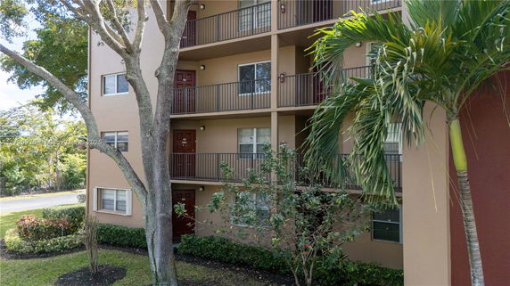 Front view of a multi-story apartment building with balconies.