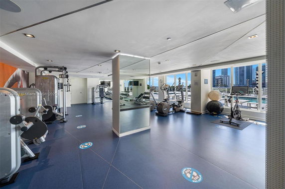 Indoor gym area with various exercise machines and equipment.