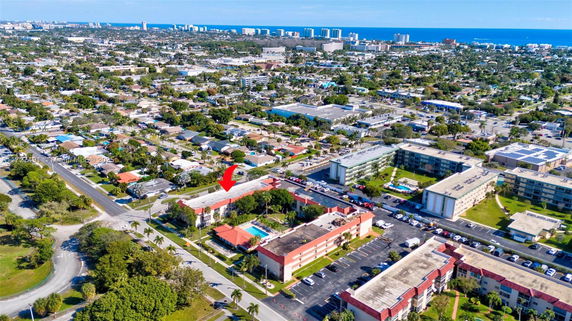 Aerial view of a residential neighborhood with apartment complexes and surrounding cityscape.