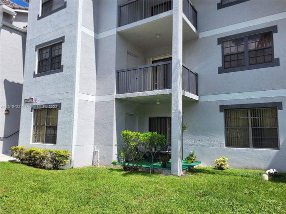 Front view of a multi-story residential building with balconies.