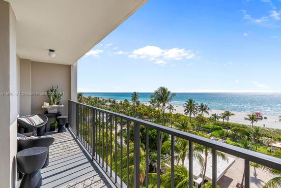 View from a balcony overlooking the beach and ocean.