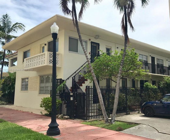 Front view of a two-story apartment building with balconies.